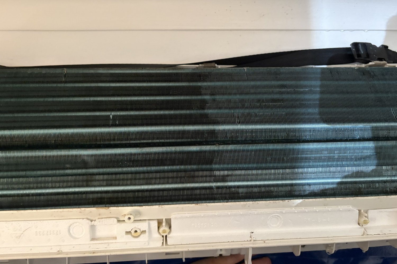 Indoor coil fins coated in dust before a service