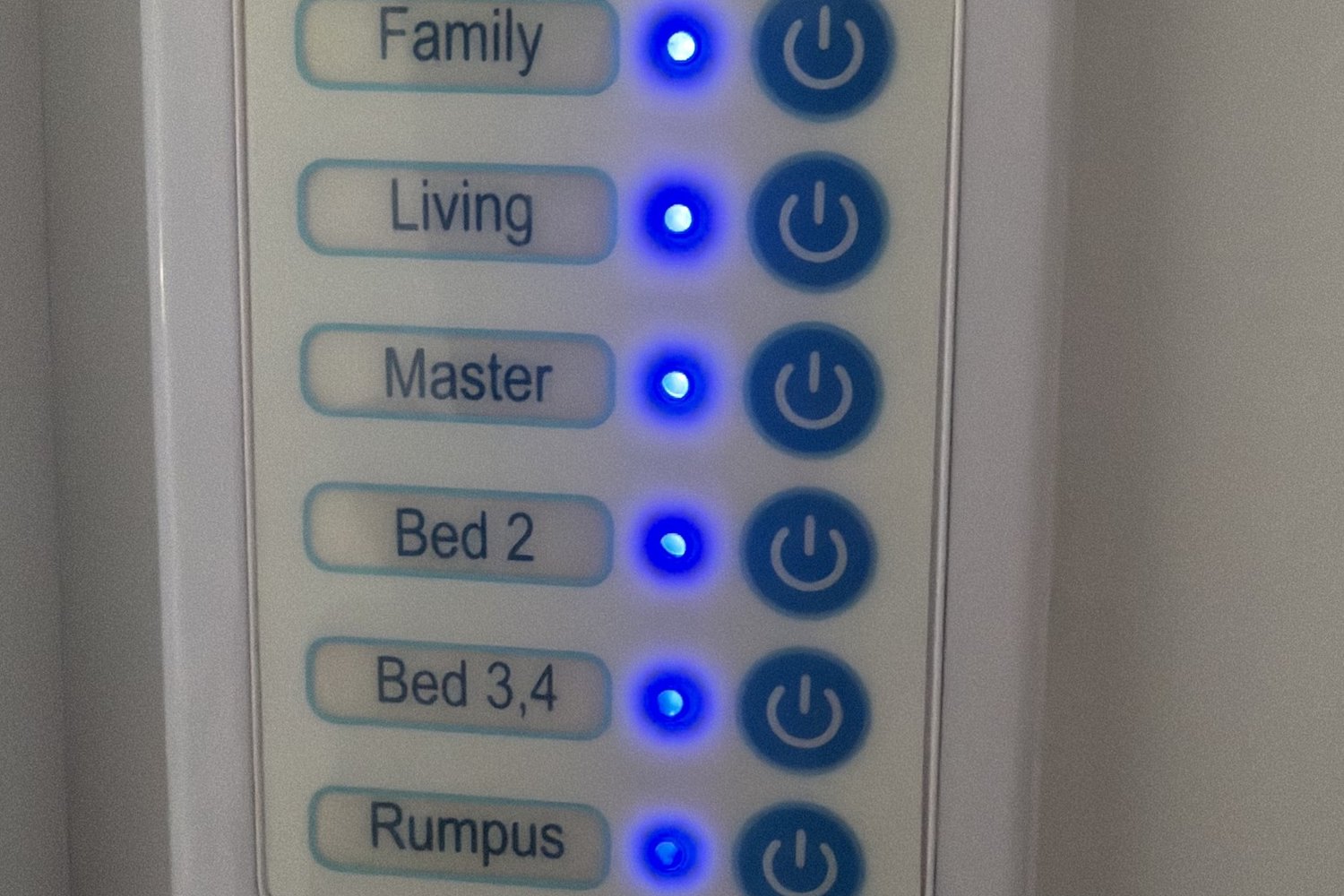 Wall mounted zone control panel with buttons for living areas and bedrooms